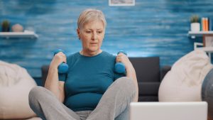 pensioner training with dumbbells